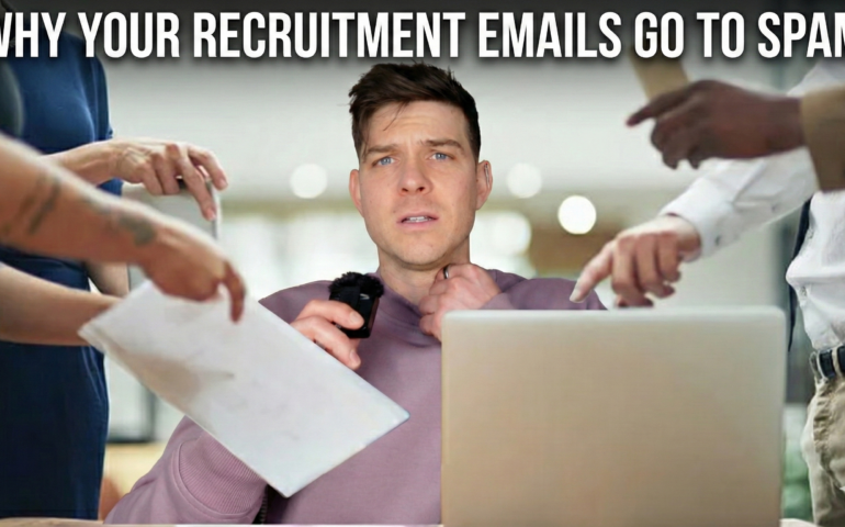 A stressed recruiter sitting at a laptop being overwhelmed by pointing fingers and paperwork, with the headline 'Why Your Recruitment Emails Go to Spam'